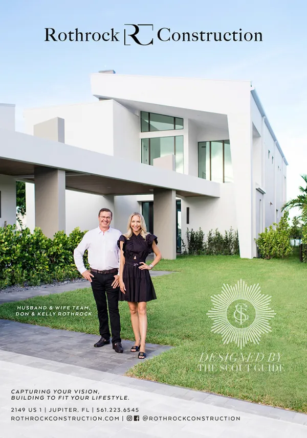 Don and Kelly Rothrock in front of a large, white, modern style luxury home.