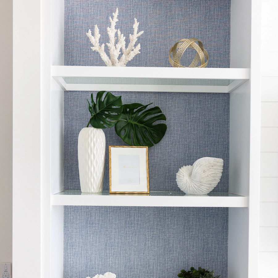 beautiful costal accessories line the glass shelves