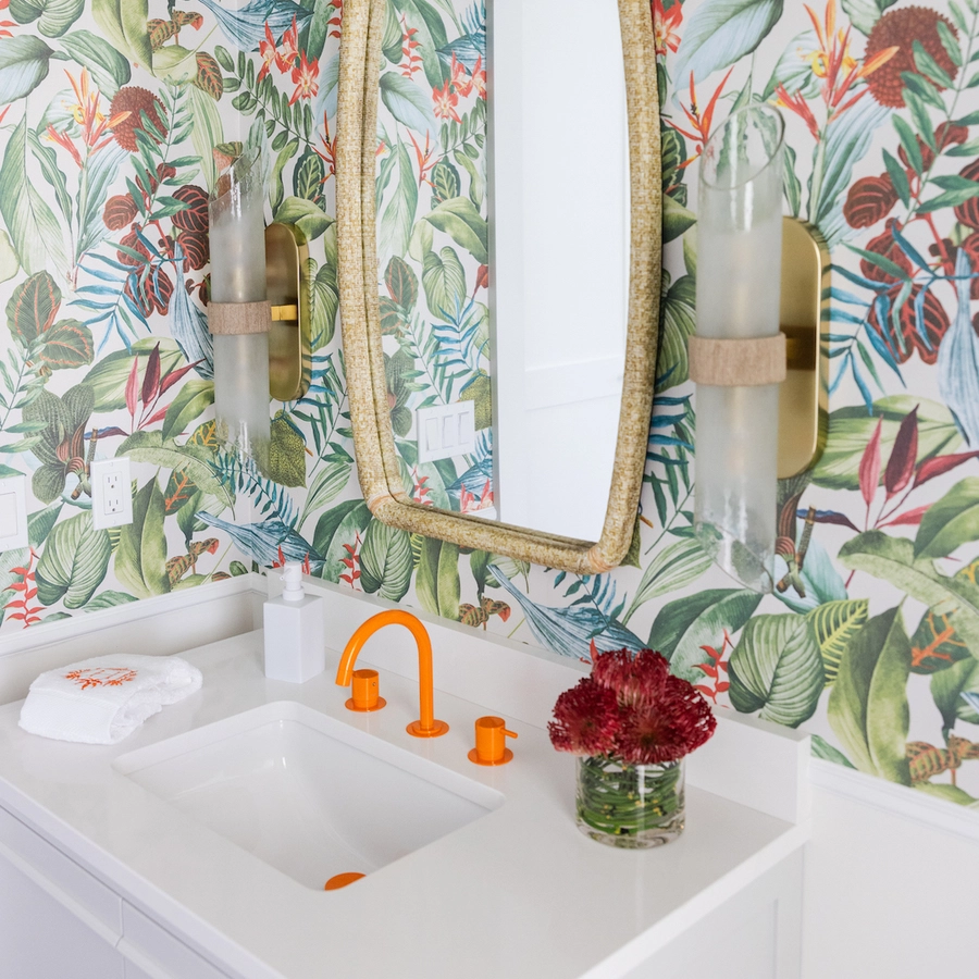 a tropical style powder bath accenting the vola orange faucet