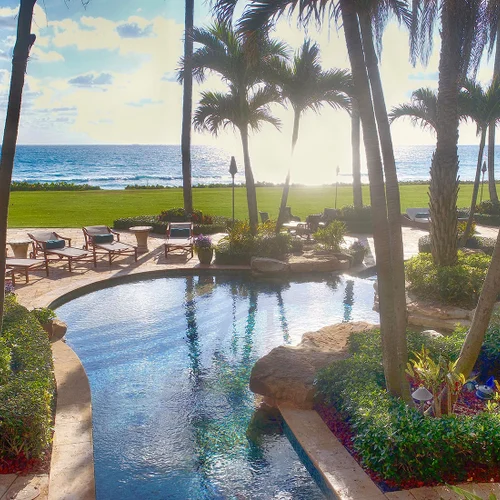 pool overlooking ocean sunset in lite up the night