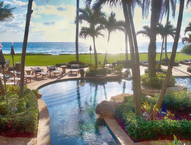 pool overlooking ocean sunset in lite up the night