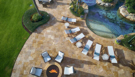 aerial view of seating area and pool of lite up the night