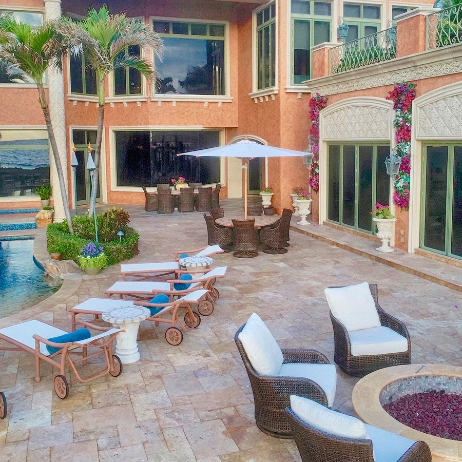 elegant look of seating area, pool and home of lite up the night