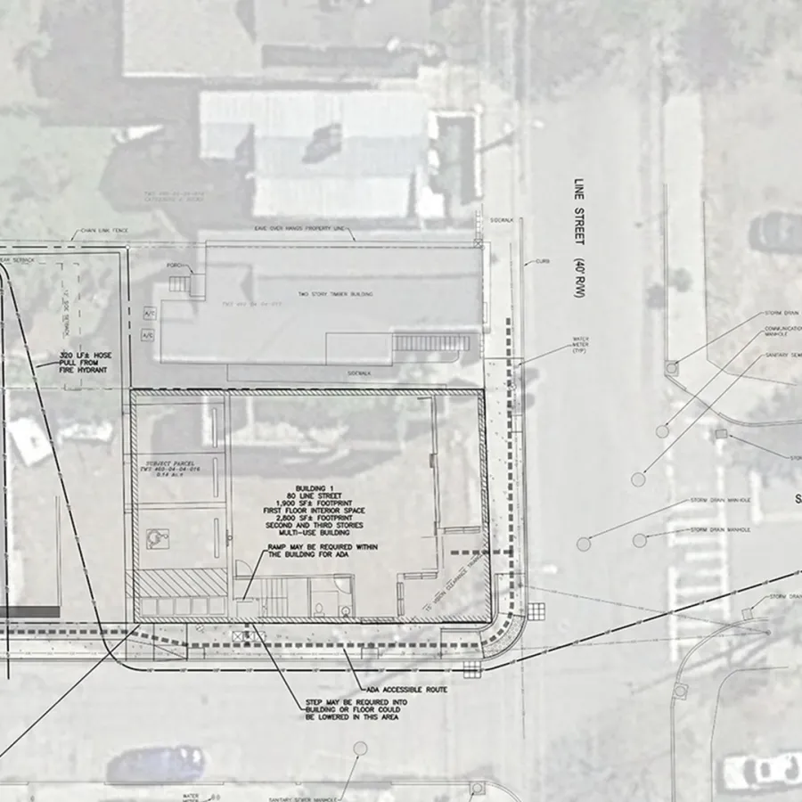A lined drawing over a bird's eye view of a building