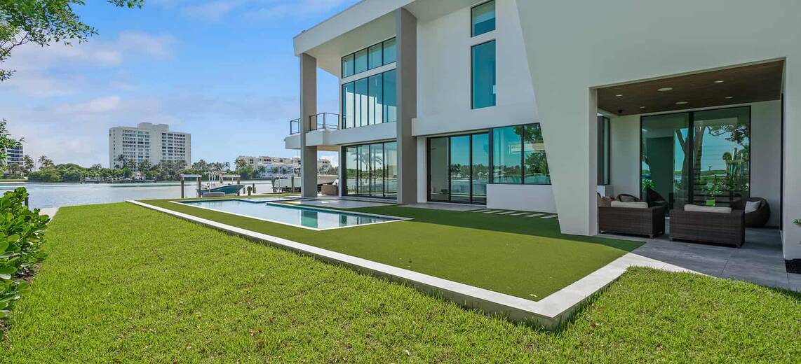 Backyard of a modern waterfront home with a pool