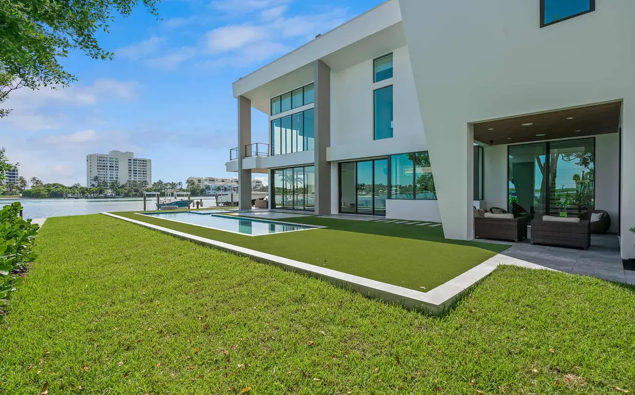 Backyard of a modern waterfront home with a pool