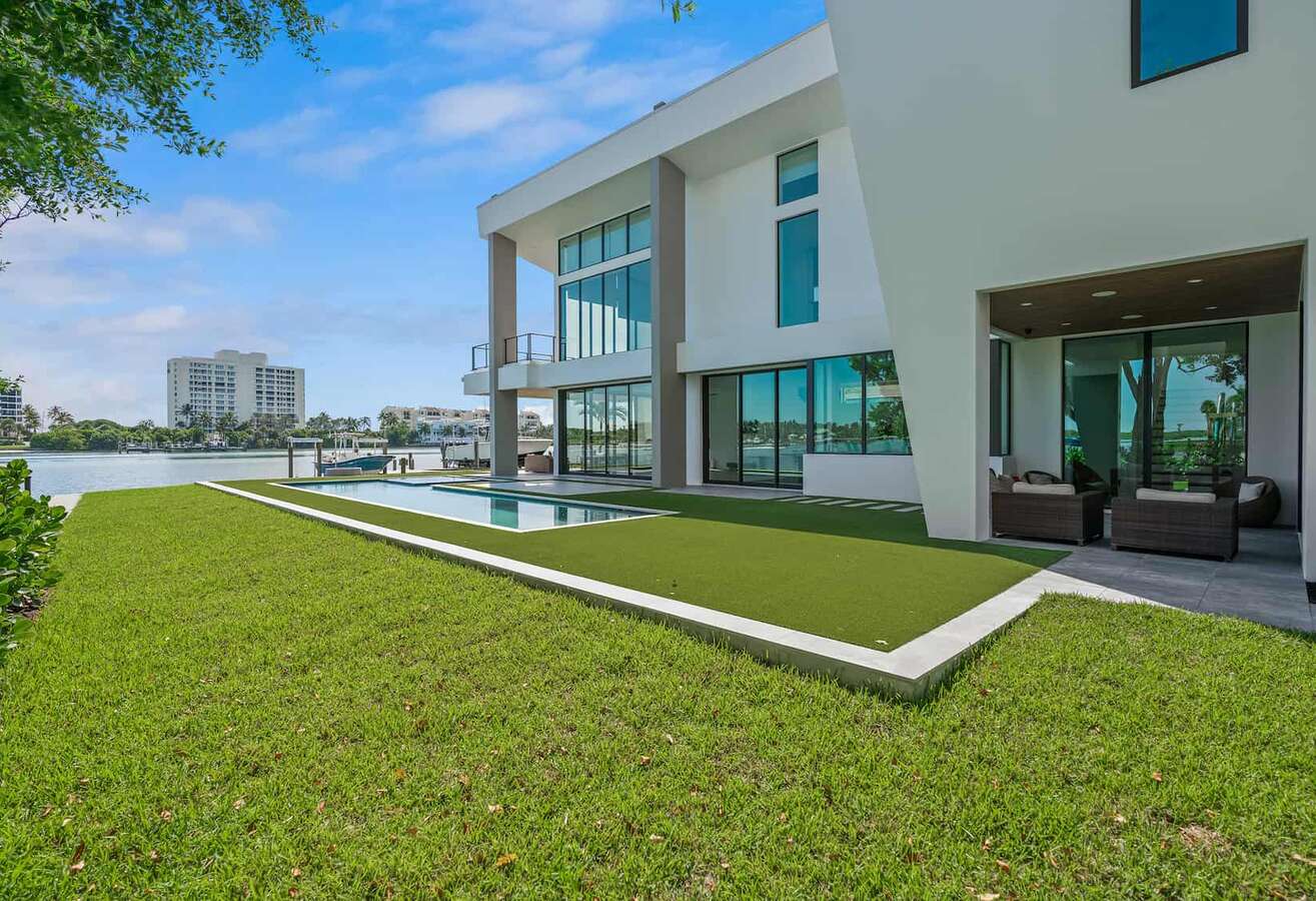 Backyard of a modern waterfront home with a pool