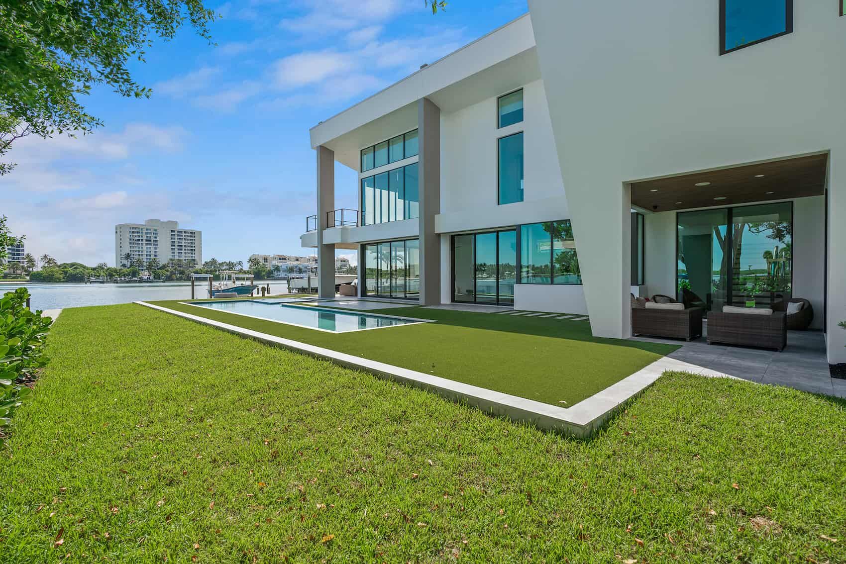 Backyard of a modern waterfront home with a pool