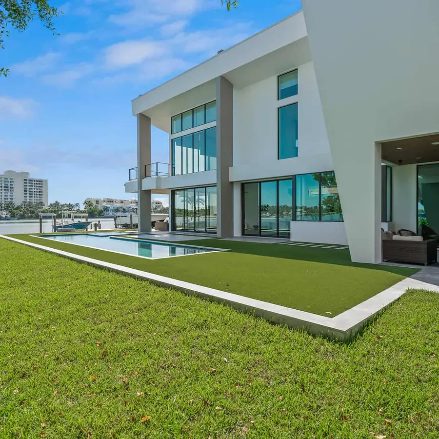 Backyard of a modern waterfront home with a pool