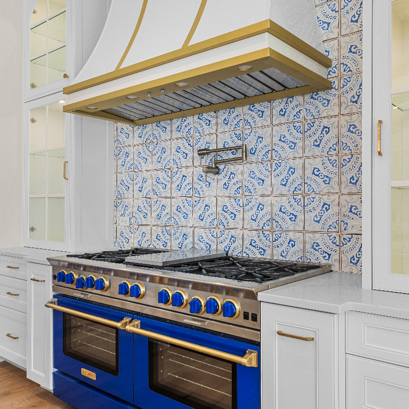 kitchen with a high-end blue range and Tuscan style back splash