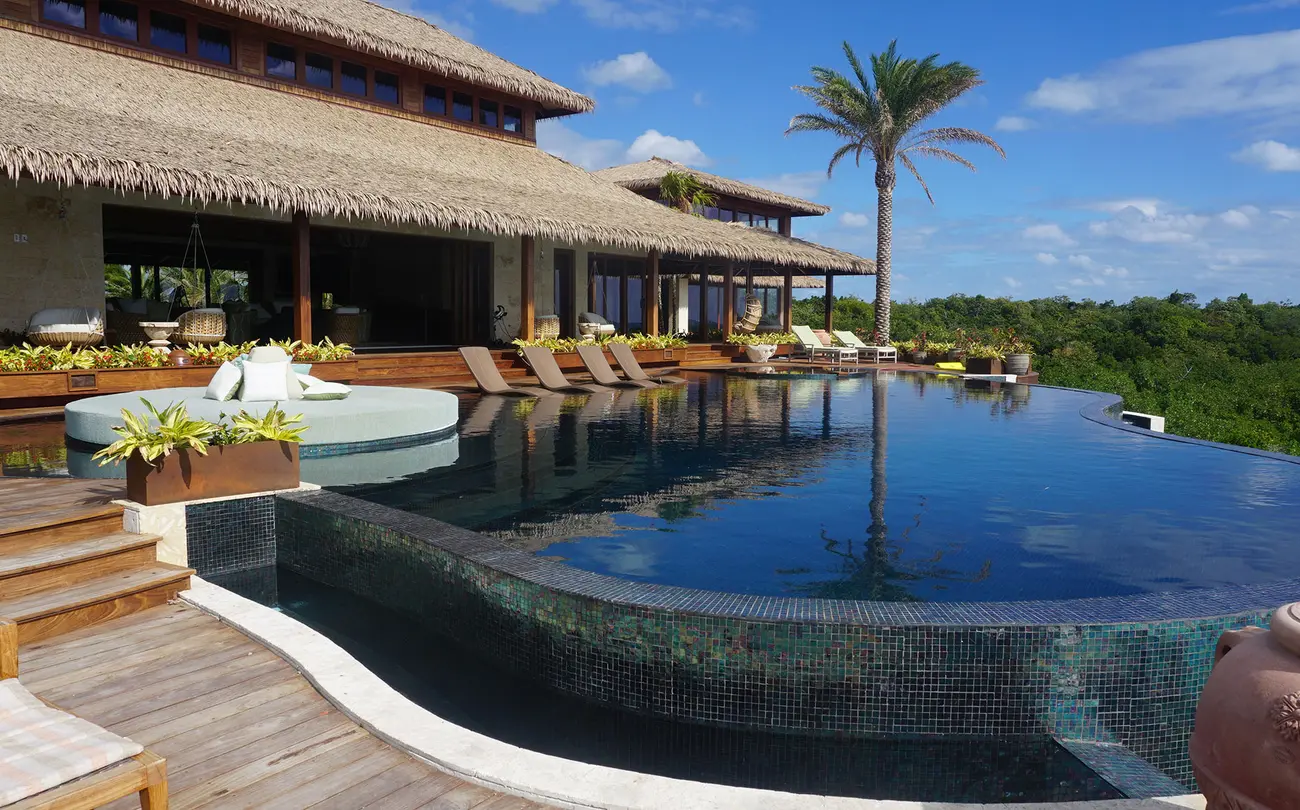 The infinity pool and some of the buildings of the private island retreat