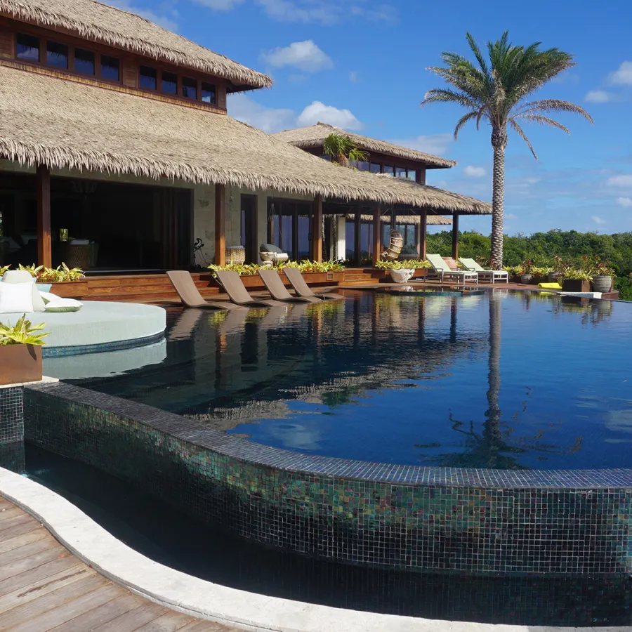 The infinity pool and some of the buildings of the private island retreat