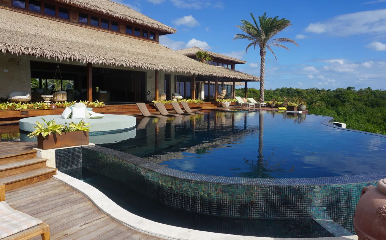 The infinity pool and some of the buildings of the private island retreat