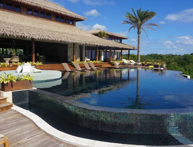 The infinity pool and some of the buildings of the private island retreat