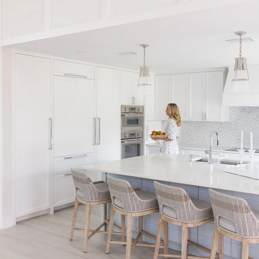 Minimalist kitchen with monochrome palette and integrated appliances.