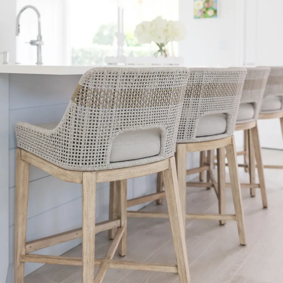 Coastal bar stools with woven texture and sleek island.