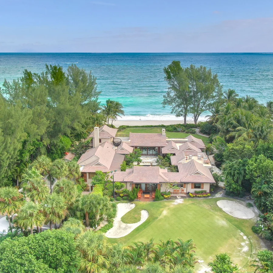 oceanfront house with numerous trees around it and in walking distance to the beach