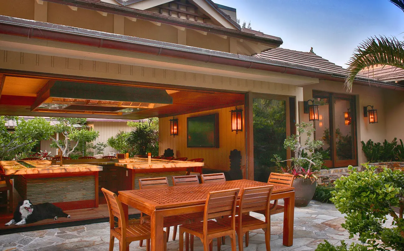 outside table with a beautiful inside kitchen