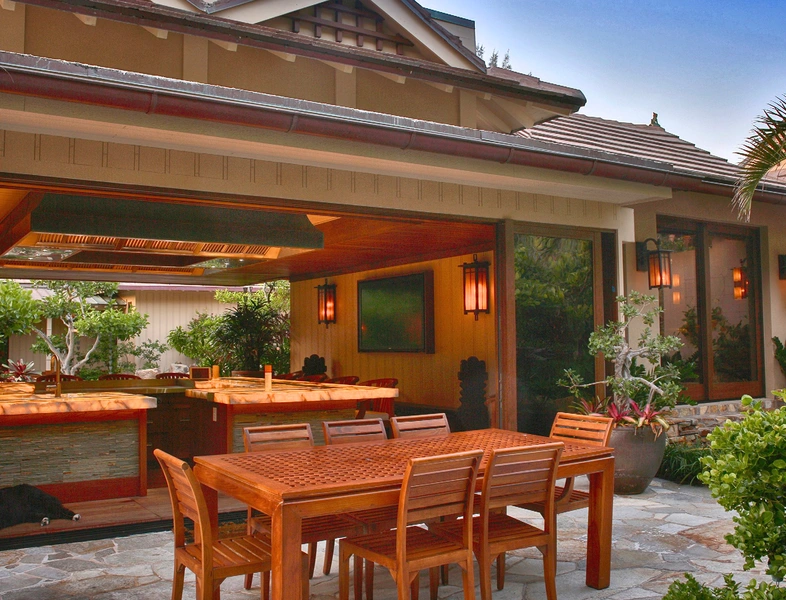 outside table with a beautiful inside kitchen