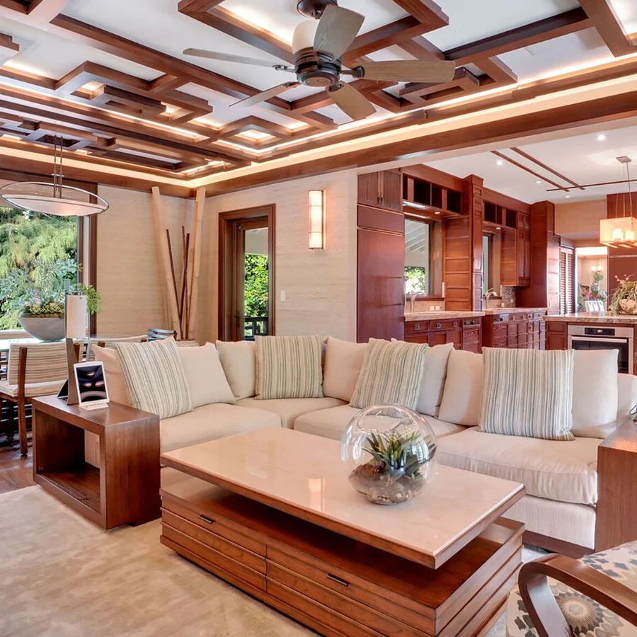 A simple living room and family dining area with the kitchen visible in the back