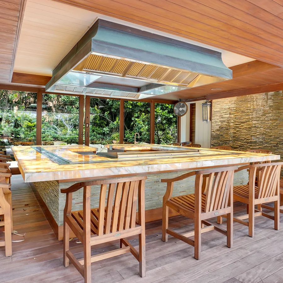 A cooking station that almost completely encircled in counters and chairs for eating